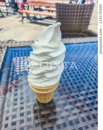Ice cream cone on the table at summer time. 128170304