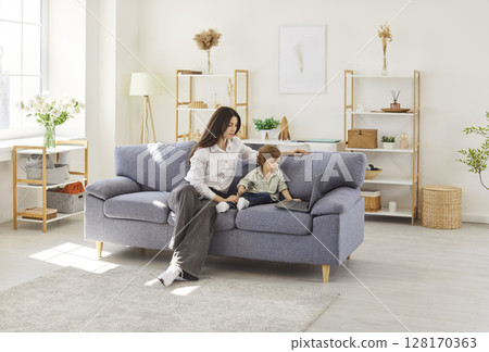 Family of mother and son, babysitter, cute little kids children enjoy using laptop watching 128170363