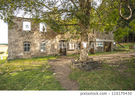 Exploring the historic ruins of Konigsmuhle in the Ore Mountains reveals remnants of stone architecture surrounded by nature. The site evokes a sense of history and tranquility. 128170430