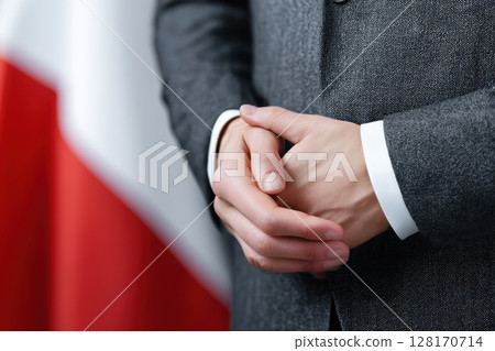 Professional attire complemented by a flag background conveying authority and culture Professional attire complemented by a flag background conveying authority and culture 128170714