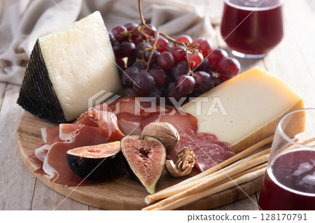 Charcuterie Board with Cheese, Grapes, and Figs Charcuterie Board with Cheese, Grapes, and Figs 128170791