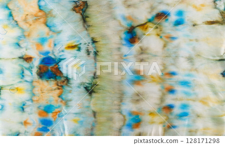 abstract pattern on silk fabric texture in blue, yellow, green colors 128171298