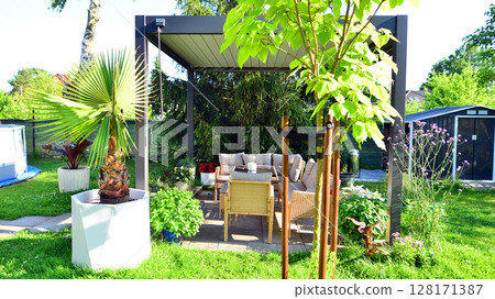 Modern aluminum pergola with stylish garden furniture in a beautiful garden. Modern aluminum pergola with stylish garden furniture in a beautiful garden. 128171387