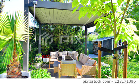 Modern aluminum pergola with stylish garden furniture in a beautiful garden. Modern aluminum pergola with stylish garden furniture in a beautiful garden. 128171390