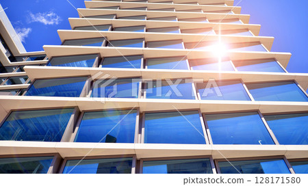 Downtown corporate business district architecture. Glass reflective office buildings against blue sky and sun light. Economy, finances, business activity concept. Abstract modern architecture fragment 128171580