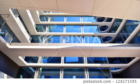 Downtown corporate business district architecture. Glass reflective office buildings against blue sky and sun light. Economy, finances, business activity concept. Abstract modern architecture fragment 128171595
