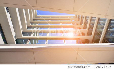 Downtown corporate business district architecture. Glass reflective office buildings against blue sky and sun light. Economy, finances, business activity concept. Abstract modern architecture fragment Downtown corporate business district architecture. Glass reflective office buildings against blue sky and sun light. Economy, finances, business activity concept. Abstract modern architecture fragment 128171596
