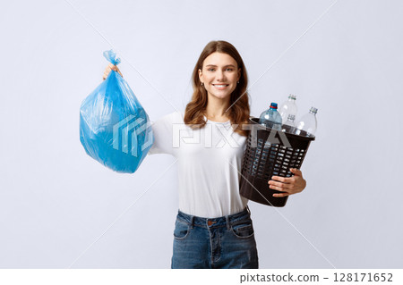 Garbage Sorting. Smiling Millennial Woman Holding Waste Bag And Bucket With Plastic Bottles, Eco-Friendly Lady Enjoying Trash Recycling, Standing Over Light Grey Studio Background, Copy Space Garbage Sorting. Smiling Millennial Woman Holding Waste Bag And Bucket With Plastic Bottles, Eco-Friendly Lady Enjoying Trash Recycling, Standing Over Light Grey Studio Background, Copy Space 128171652