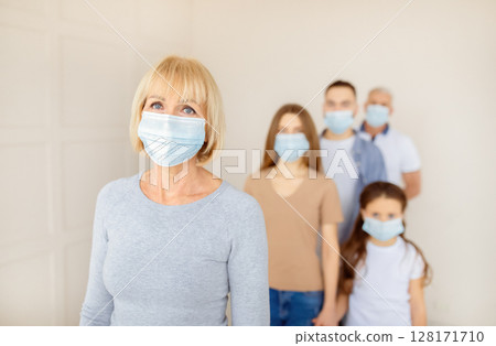 Senior woman in face mask waiting in line for vaccine against coronavirus at hospital, empty space. Mature female patient standing in queue for population covid-19 immunization Senior woman in face mask waiting in line for vaccine against coronavirus at hospital, empty space. Mature female patient standing in queue for population covid-19 immunization 128171710