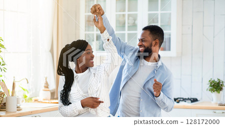 Domestic Date. Cheerful Black Lovers Dancing In Kitchen, Having Fun At Home While Having Romantic Lunch With Spaghetti Meal And Red Wine, Millennial African Spouses Enjoying Spending Time Together Domestic Date. Cheerful Black Lovers Dancing In Kitchen, Having Fun At Home While Having Romantic Lunch With Spaghetti Meal And Red Wine, Millennial African Spouses Enjoying Spending Time Together 128172000