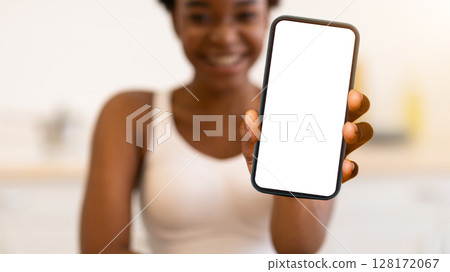 Black Woman Showing Green Smoothie Bottle To Camera Indoors. Detox Diet For Weight Loss And Slimming. African Lady Losing Weight Eating Healthy Veggie Food. Selective Focus On Smoothie Drink 128172067