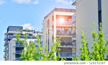 European residential architecture harmonizing with nature. Eco-friendly living in city with greens. Eco apartment building saving energy and fresh air concept.  128172167