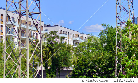 European residential architecture harmonizing with nature. Eco-friendly living in city with greens. Eco apartment building saving energy and fresh air concept. European residential architecture harmonizing with nature. Eco-friendly living in city with greens. Eco apartment building saving energy and fresh air concept. 128172195