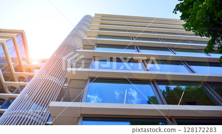Downtown corporate business district architecture. Glass reflective office buildings against blue sky and sun light. Economy, finances, business activity concept. Abstract modern architecture fragment 128172283