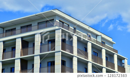 Modern apartment buildings on a sunny day with a blue sky. Facade of a modern apartment building. Modern residential apartment building complex condo. 128172383