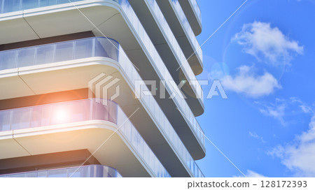 Modern apartment buildings on a sunny day with a blue sky. Facade of a modern apartment building. Modern residential apartment building complex condo. 128172393