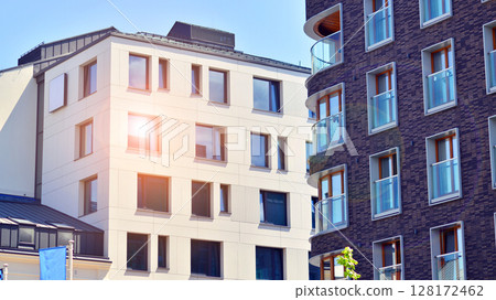 Modern apartment buildings on a sunny day with a blue sky. Facade of a modern apartment building. Modern residential apartment building complex condo. Modern apartment buildings on a sunny day with a blue sky. Facade of a modern apartment building. Modern residential apartment building complex condo. 128172462