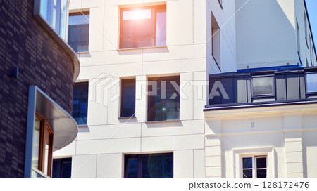 Modern apartment buildings on a sunny day with a blue sky. Facade of a modern apartment building. Modern residential apartment building complex condo. Modern apartment buildings on a sunny day with a blue sky. Facade of a modern apartment building. Modern residential apartment building complex condo. 128172476