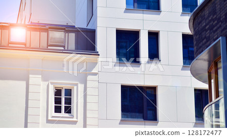 Modern apartment buildings on a sunny day with a blue sky. Facade of a modern apartment building. Modern residential apartment building complex condo. Modern apartment buildings on a sunny day with a blue sky. Facade of a modern apartment building. Modern residential apartment building complex condo. 128172477