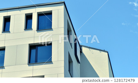 Modern apartment buildings on a sunny day with a blue sky. Facade of a modern apartment building. Modern residential apartment building complex condo. 128172479