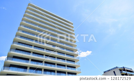 Exterior of a high modern multi-story apartment building - facade, windows and balconies. Exterior of a high modern multi-story apartment building - facade, windows and balconies. 128172529
