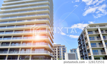 Exterior of a high modern multi-story apartment building - facade, windows and balconies. 128172531