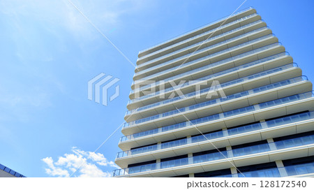 Exterior of a high modern multi-story apartment building - facade, windows and balconies. 128172540