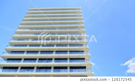 Exterior of a high modern multi-story apartment building - facade, windows and balconies. Exterior of a high modern multi-story apartment building - facade, windows and balconies. 128172545