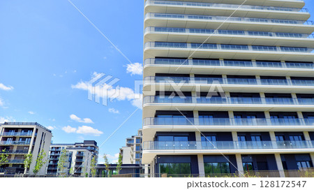 Exterior of a high modern multi-story apartment building - facade, windows and balconies. 128172547