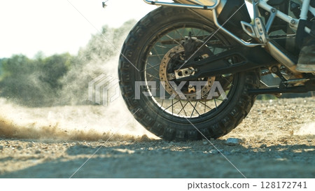 Detail view of the wheel of motocross bike. Freeze motion of exploding clay. 128172741