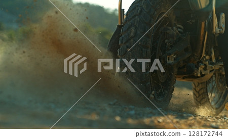 Detail view of the wheel of motocross bike. Freeze motion of exploding clay. 128172744