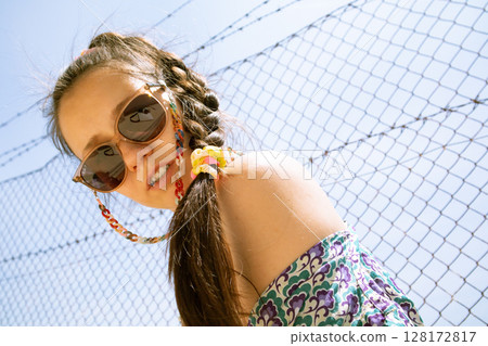 Young stylish beautiful brunette sexy girl, woman on street in summer. Boho woman portrait in sunglasses. People outdoors. Fashionable female portrait 128172817