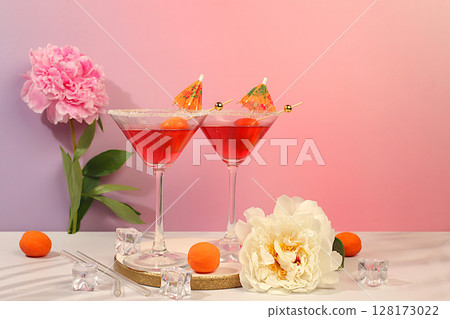 Minimal summer party concept, advertising banner for bar, cafe. Modern still life with pink martini, summer alcoholic cocktail with apricot for party and peonies on elegant modern background 128173022