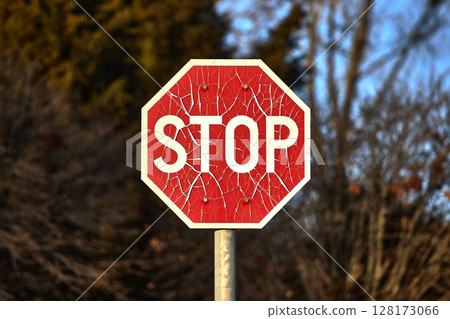 Stop sign with broken paint peeling Stop sign with broken paint peeling 128173066