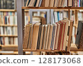 Books and shelves of a library 128173068