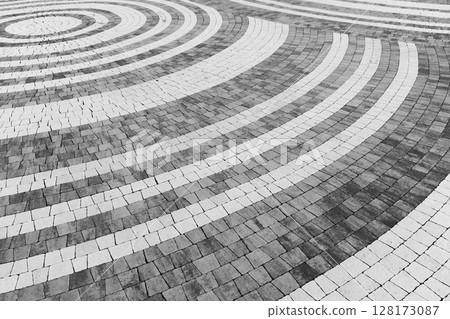 Artistic pattern of concentric white circular lines, decorative stone pavement 128173087