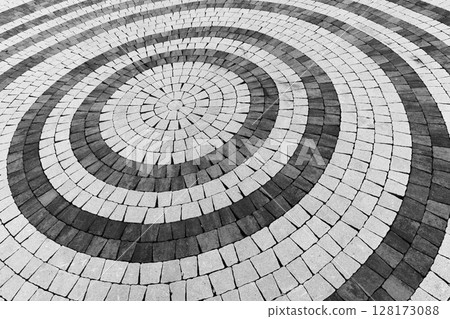 Abstract close-up view of a circular paving pattern, background texture Abstract close-up view of a circular paving pattern, background texture 128173088