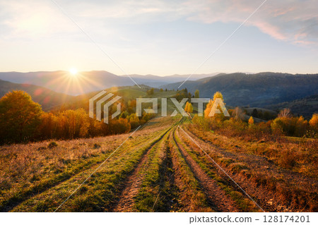 A country road winds through picturesque hills 128174201