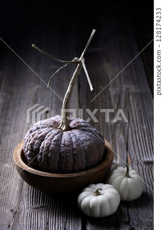 Japanese Black Futsu pumpkin sits on wooden bowl o 128174233