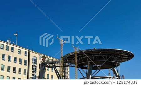 A Modern Communication Tower Set Against a Clear Blue Sky, Showcasing Urban Innovation and Design 128174332