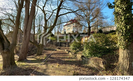 A Serene Outdoor Scene Featuring a Beautiful House Surrounded by Lush Nature and Landscapes 128174347