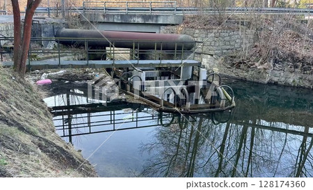 A Tranquil Waterway Scene Featuring an Industrial Structure, with Beautiful Reflections A Tranquil Waterway Scene Featuring an Industrial Structure, with Beautiful Reflections 128174360