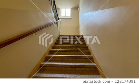 Exploring Stairway Perspective Bathed in Soft, Warm Lighting for a Captivating Atmosphere 128174391