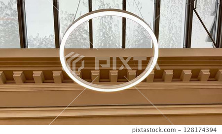 A Contemporary Circular Pendant Light that enhances the Elegant Architectural Setting beautifully 128174394