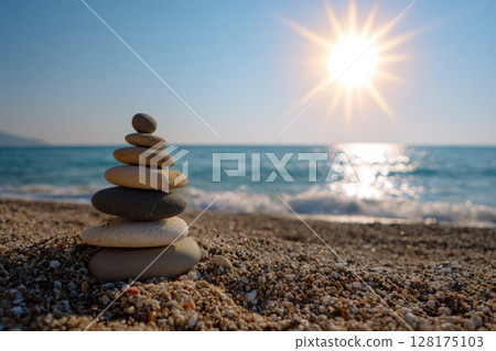 A stack of rocks on a beach with the sun shining on them 128175103