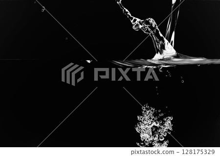 A lot of air bubbles flying into the water on a black background. A lot of air bubbles flying into the water on a black background. 128175329