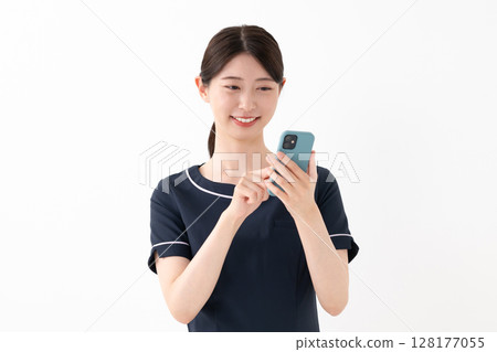 A woman using a smartphone A woman using a smartphone 128177055
