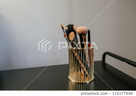 Makeup Brushes in Elegant Gold Holder on Display 128177640