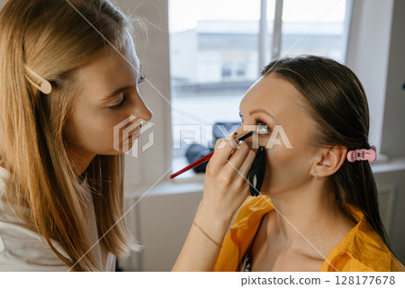 Makeup Artist Applying Foundation to Client in Salon Makeup Artist Applying Foundation to Client in Salon 128177678