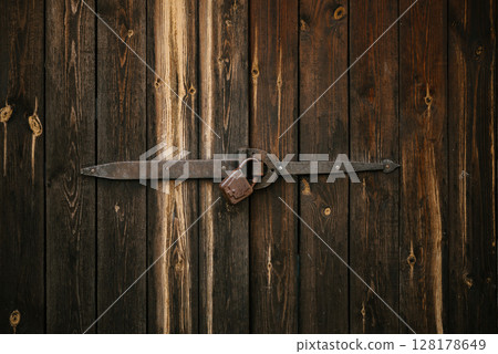 Rustic Wooden Door with Iron Lock and Padlock 128178649